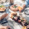 People sharing platters and pizza and drinking on Waiheke Island