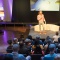 Presenter on stage at a conference
