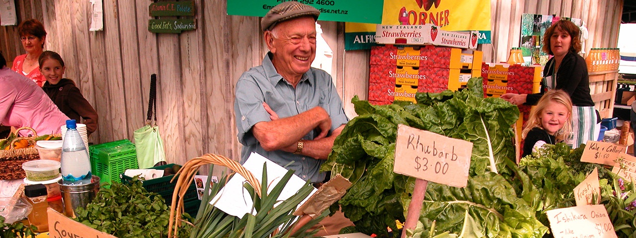A happy vendor behind his fresh produce at Clevedon Markets A happy vendor behind his fresh produce at Clevedon Markets