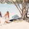 Two woman walking on the beach at Man O War on Waiheke Island